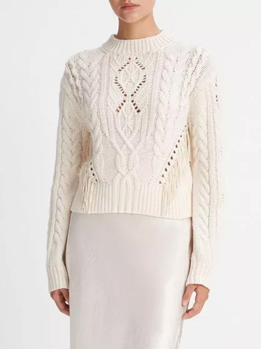 A woman wearing a Vince Fringe Merino Wool-Cashmere Cable Sweater in Cream and a white skirt.