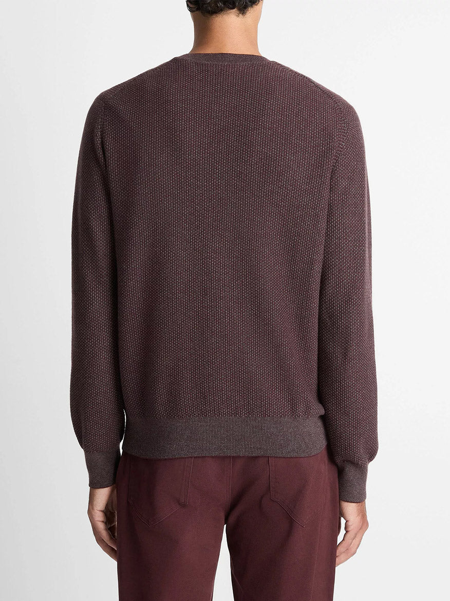 A person stands with their back to the camera, wearing the Vince Geo-Jacquard Wool-Blend Crew Neck Sweater in Port/Medium Heather Grey against a plain light background.