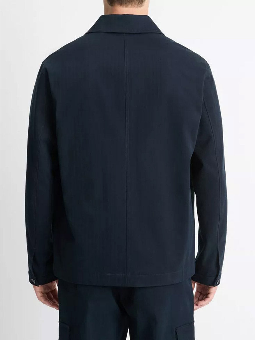 A person wearing the Vince Herringbone Cotton Chore Jacket in Coastal and coordinating pants is shown from behind against a white background.