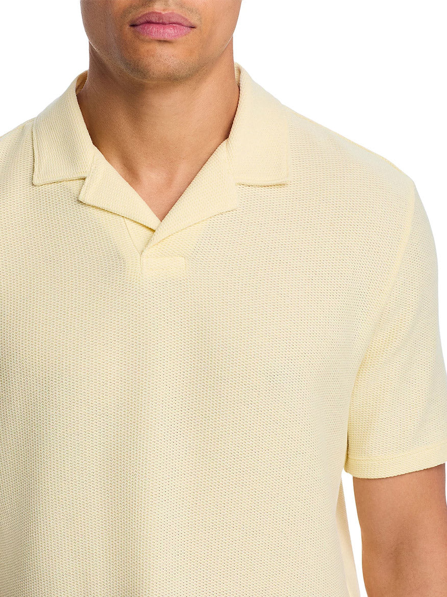 A man models the Vince Macro Honeycomb Cabana Johnny Collar Shirt in Cream, a light cotton-blend knit with textured detail, shown from shoulders to mid-torso against a white background.