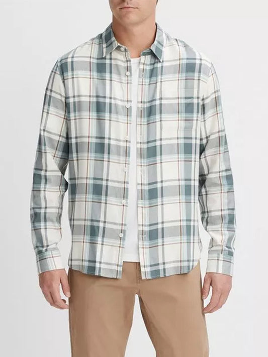 A man wearing a Vince Manchester Plaid Shirt in Bone/Dusty Teal with shades of white, blue, and green. He is also wearing beige pants. The cotton-blend shirt is untucked.