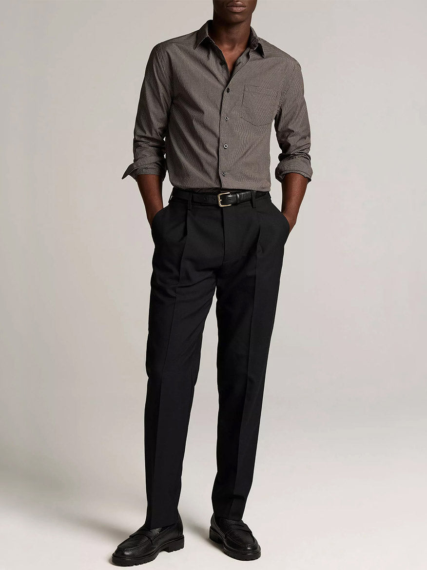 A person stands against a plain background, wearing the Vince McDermott Plaid Cotton Button-Front Shirt in Arabica/Headline Grey, paired with black dress pants, a belt, and black dress shoes. Their hands are in their pockets and their face is not visible.