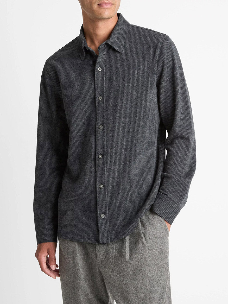 A person wearing the Vince Pinstripe Jacquard Cotton-Blend Button-Front Shirt in Charcoal and light gray pants stands against a plain white background.