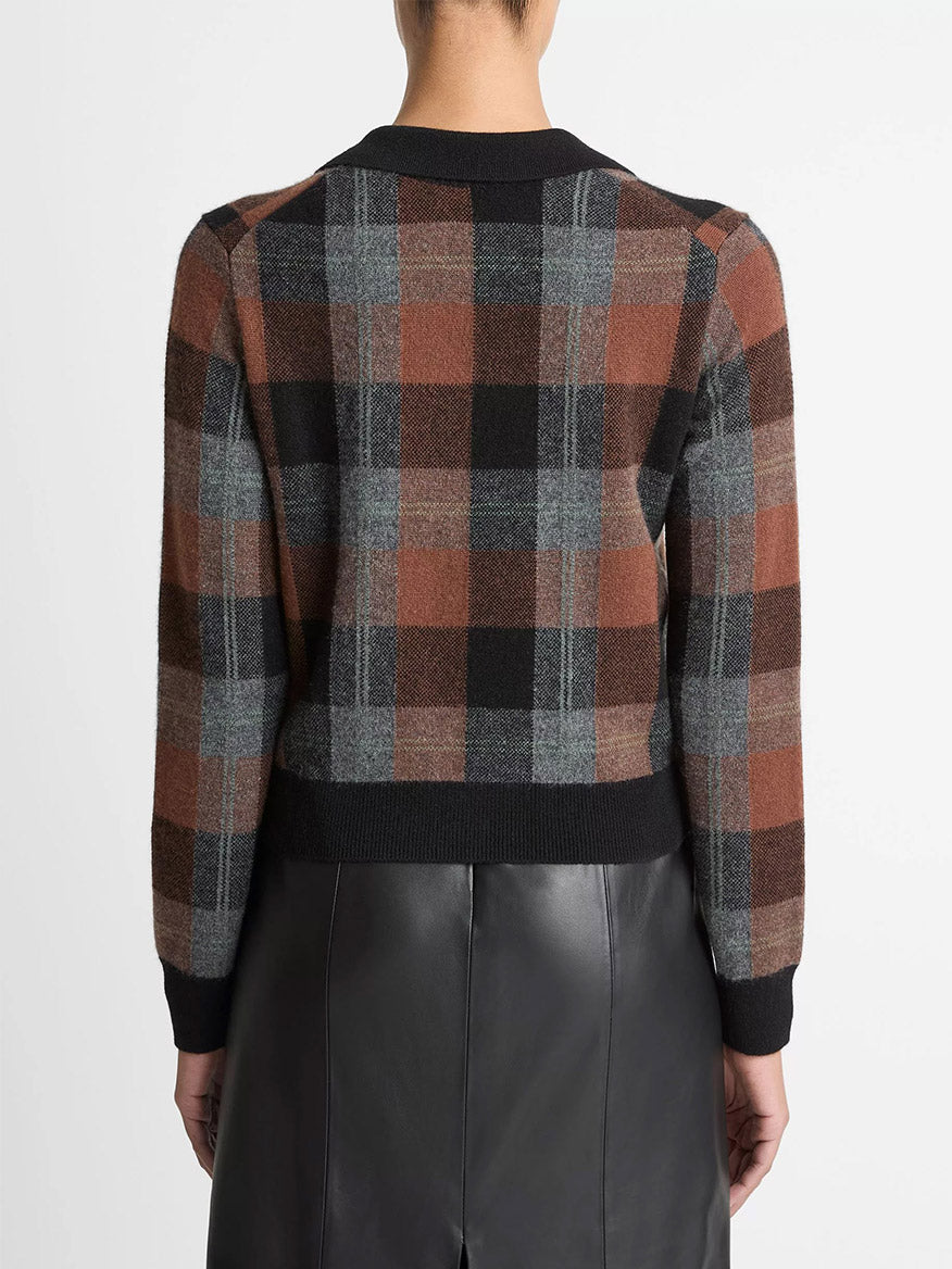 A person is shown from the back wearing the Vince Checked Plaid Cashmere Polo Cardigan in Cacao/Dark Heather Pewter/Black, paired with a black leather skirt.