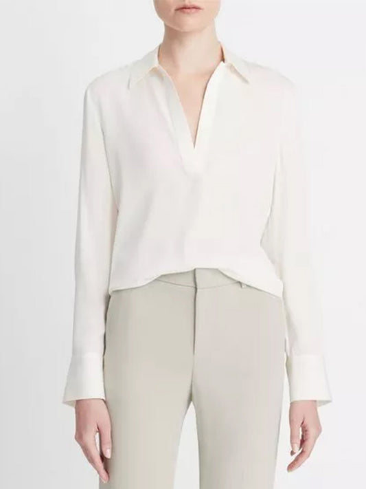 Woman wearing an elegant Vince Stretch-Silk Long-Sleeve Polo Blouse in Off-White and beige trousers.