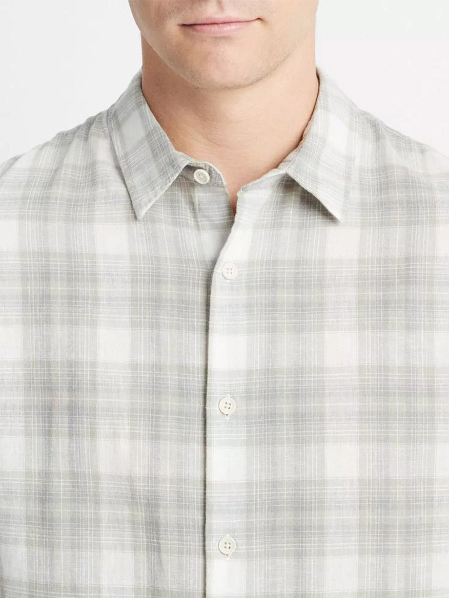 Close-up of a person wearing a Vince Salton Plaid Long-Sleeve Shirt in Alabaster/Dried Cactus.