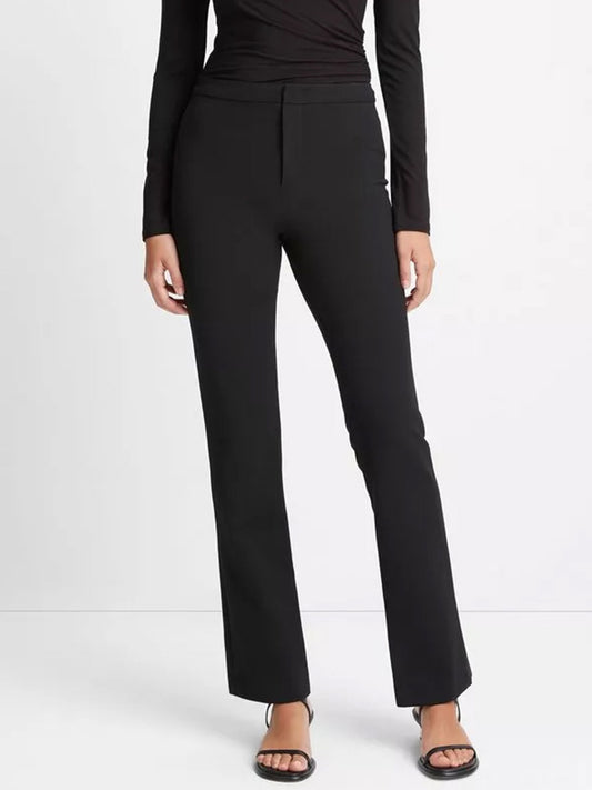 Woman wearing Vince Tapered-Leg Trouser in Black and black top with black open-toe sandals.