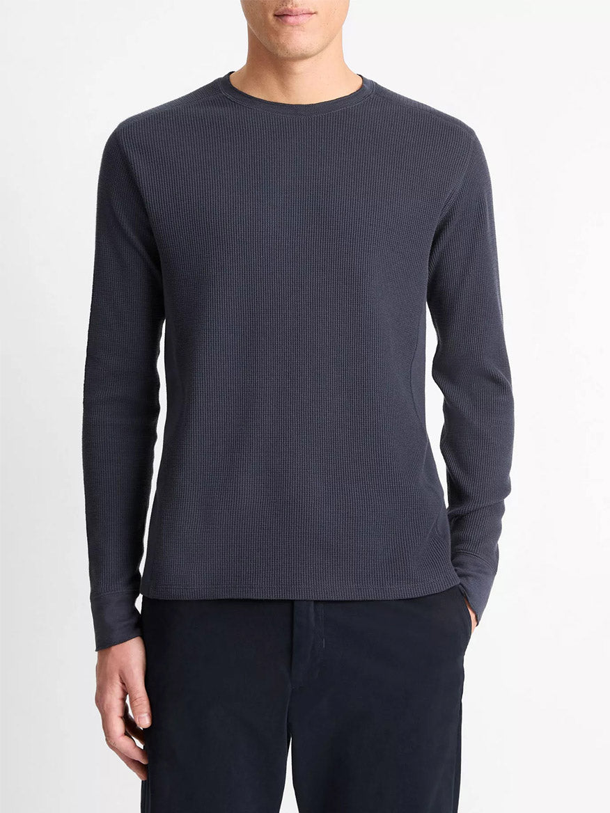 Wearing the Vince Thermal Long Sleeve Crew Neck Pullover in Coastal Blue, this person stands in dark pants against a plain white background.