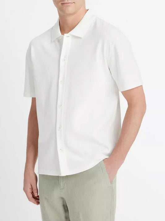 Man wearing a Vince Variegated Jacquard Short-Sleeve Button-Front Shirt in Off-White and olive pants.