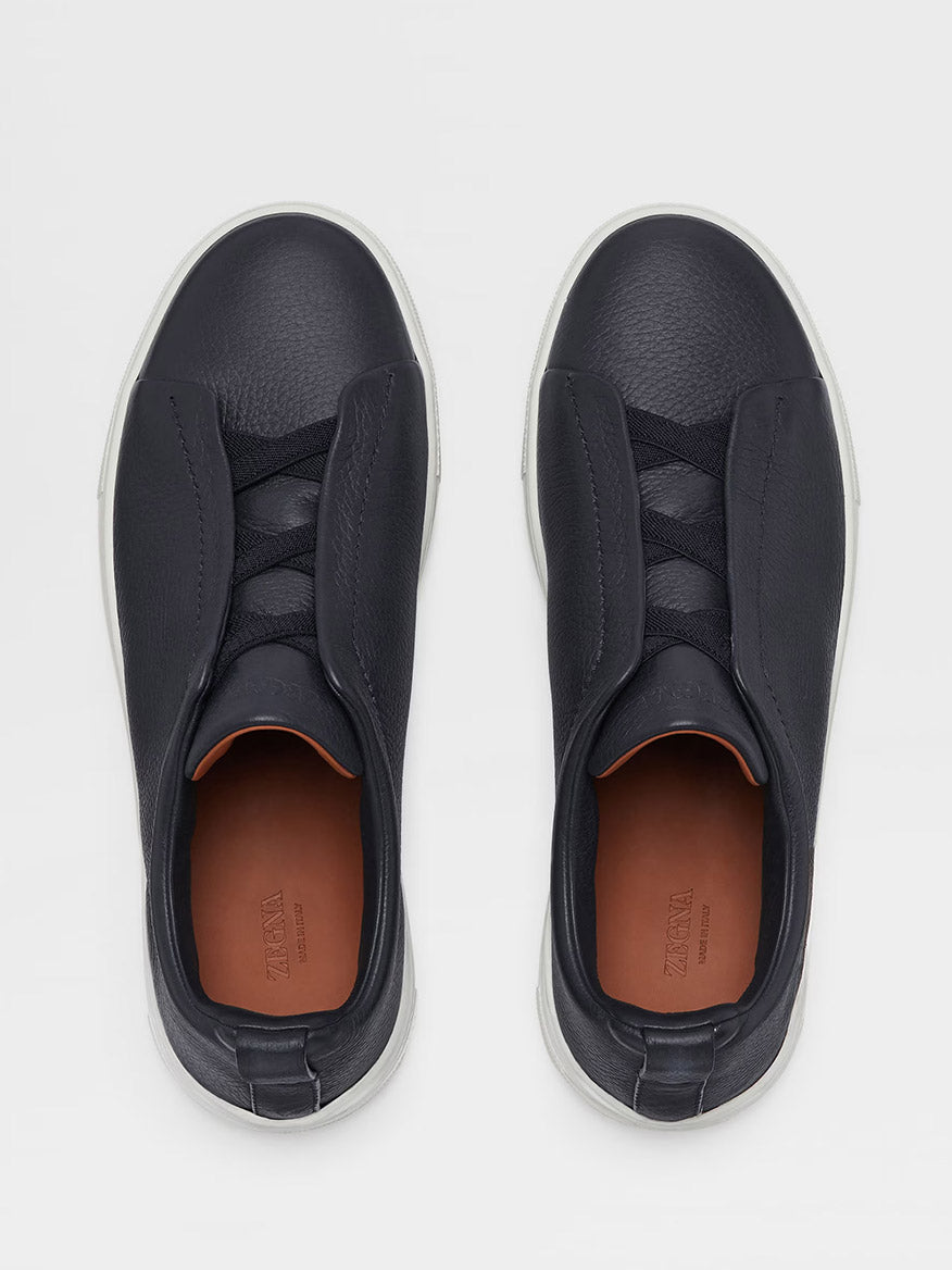 A pair of Zegna Navy Blue Deerskin Triple Stitch™ Sneakers with concealed laces under overlapping panels, viewed from above on a light background.