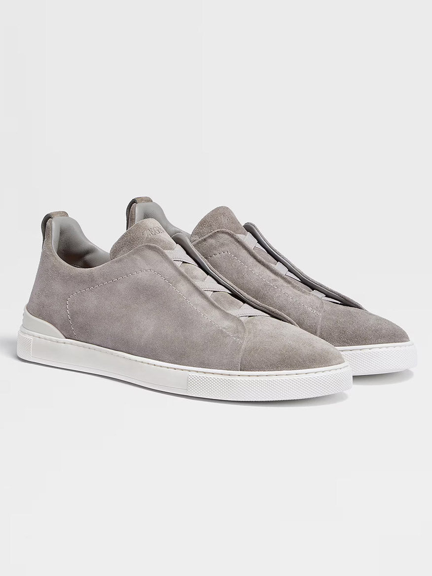 Zegna Light Grey Suede Triple Stitch™ Sneakers feature lightweight suede and white rubber soles, displayed against a plain light background to highlight their fine craftsmanship and timeless style.