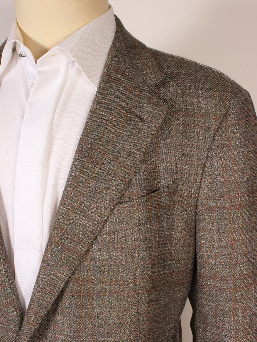 A mannequin in a light brown plaid blazer over a white dress shirt stands beside the Zegna Fairway Winter Crossover Sport Jacket in hunter green plaid, made in Italy.