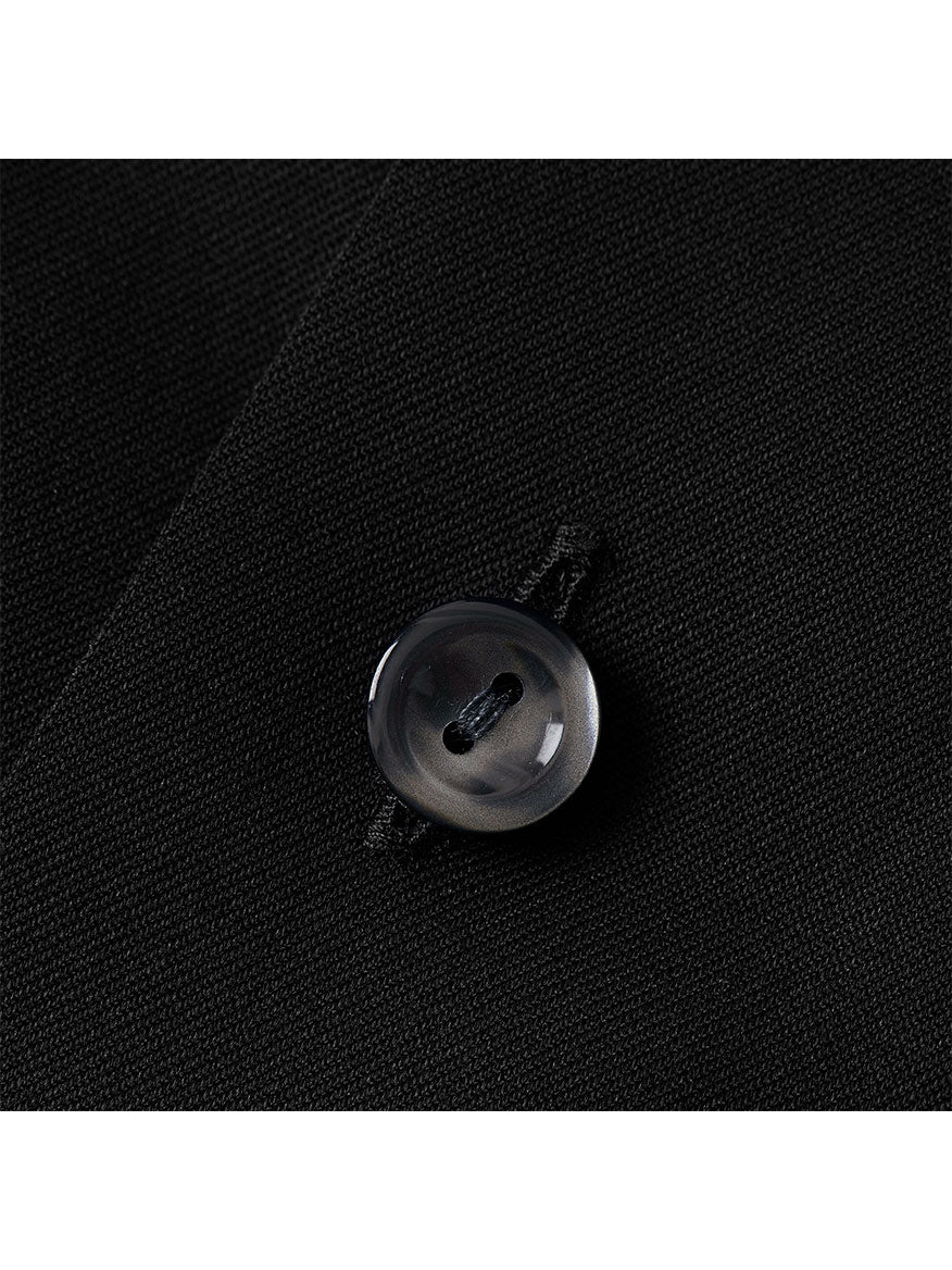 Close-up of a single gray button sewn onto the black fabric of an Eton Contemporary Fit Black Signature Twill Dress Shirt.
