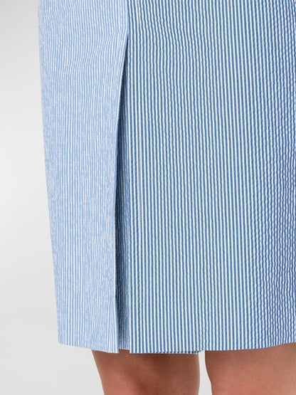 Close-up of a person wearing an Akris Punto Colorblock Seersucker Midi Skirt in Denim/Cream, focusing on the fabric detail and texture.