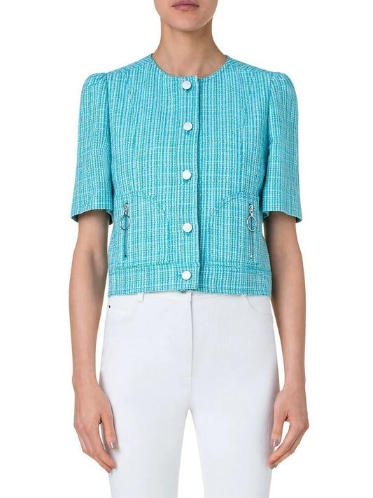 Woman wearing an Akris Punto Linen Blend Tweed Half Sleeve Jacket in Turquoise Multi with white buttons and white pants.