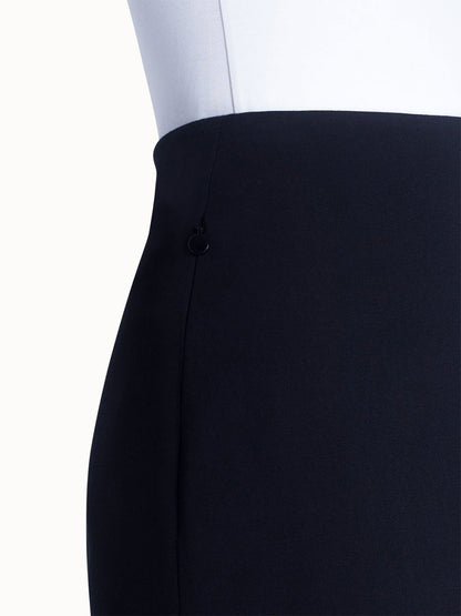 Close-up of an Akris Punto Jersey Stretch Skirt in Black with a button detail.