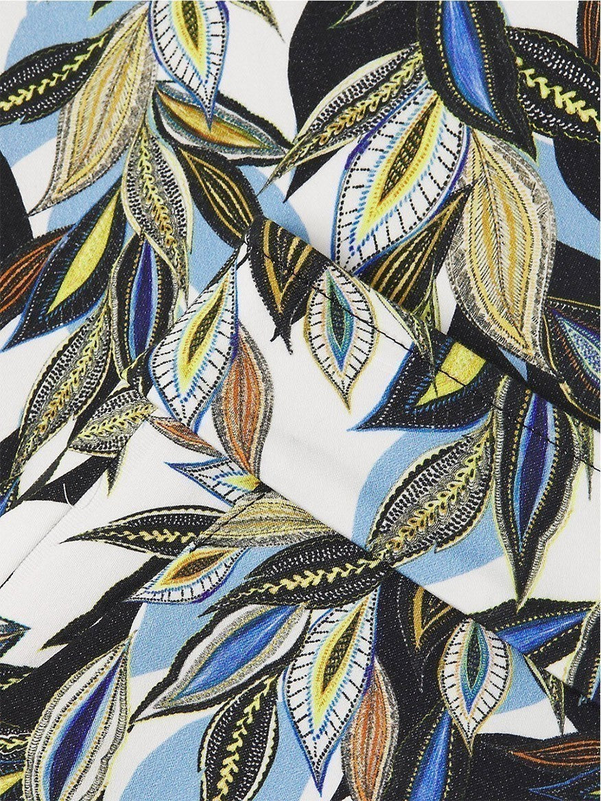 Close-up of fabric with a colorful leaf pattern design, featuring a banded waist detail reminiscent of Avenue Montaigne Lulu Leaf Print Pant in Amazing Blue Multi.