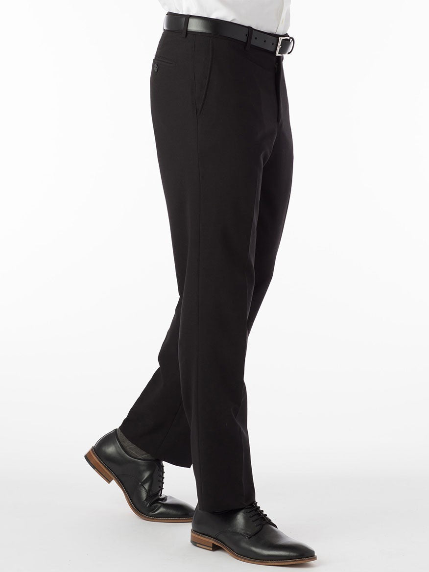 A man wearing the Ballin Connor Comfort 'EZE' Modern Flat Front Pant in Black made of stretch gabardine fabric and a white shirt.