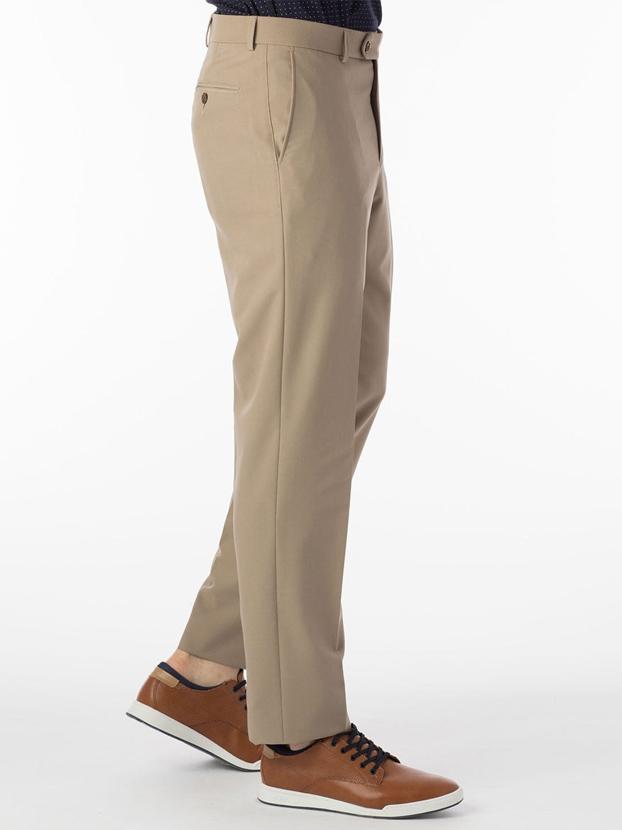 A man dressed in Ballin Connor Comfort 'EZE' Modern Flat Front Pant in Khaki exhibits total comfort while sporting black shoes made from a synthetic gabardine material, ensuring both shape retention and style.