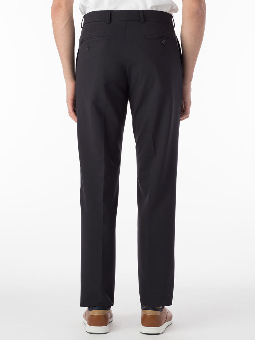 A person in stylish navy Ballin Connor Comfort 'EZE' modern flat front pants is viewed from the back against a plain white background, paired with brown shoes.