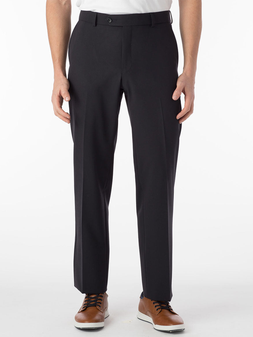 A person wearing navy modern flat front pants known as Ballin Connor Comfort 'EZE' and brown shoes stands against a plain white background.