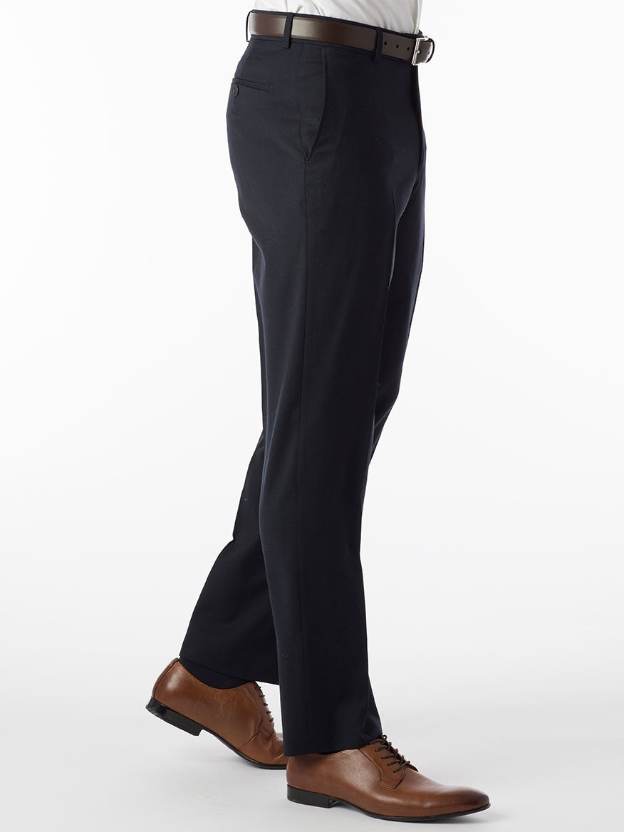 A man wearing the Ballin Theo Comfort 'EZE' Modern Flat Front Pant in Navy, made of wool gabardine, paired with a comfortable tan shirt.