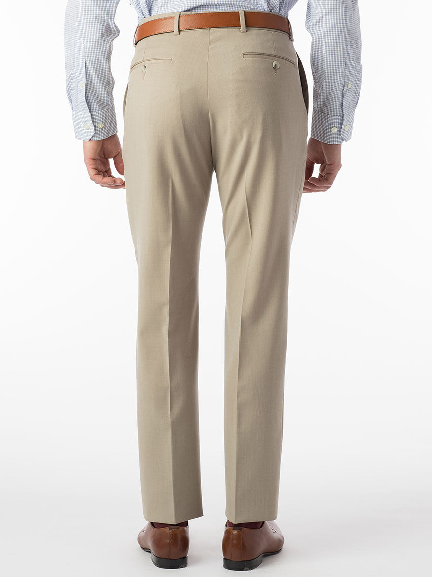 A person wearing an elegant pair of Ballin Theo Comfort 'EZE' Modern Flat Front Pants in oatmeal, paired with a blue checkered shirt and brown shoes, stands with their back to the camera.