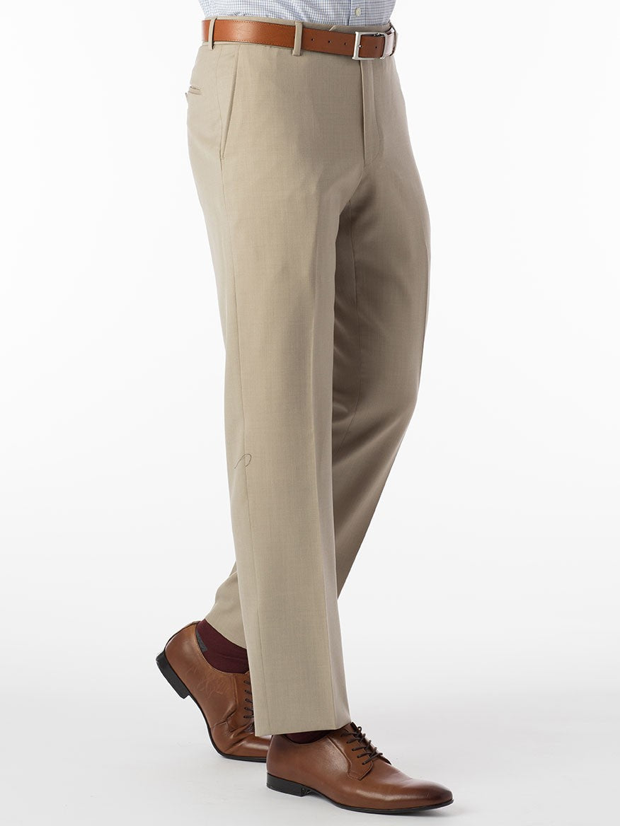 A person wearing the Ballin Theo Comfort 'EZE' Modern Flat Front Pant in Oatmeal, paired with a brown leather belt and matching leather shoes, stands against a white background.