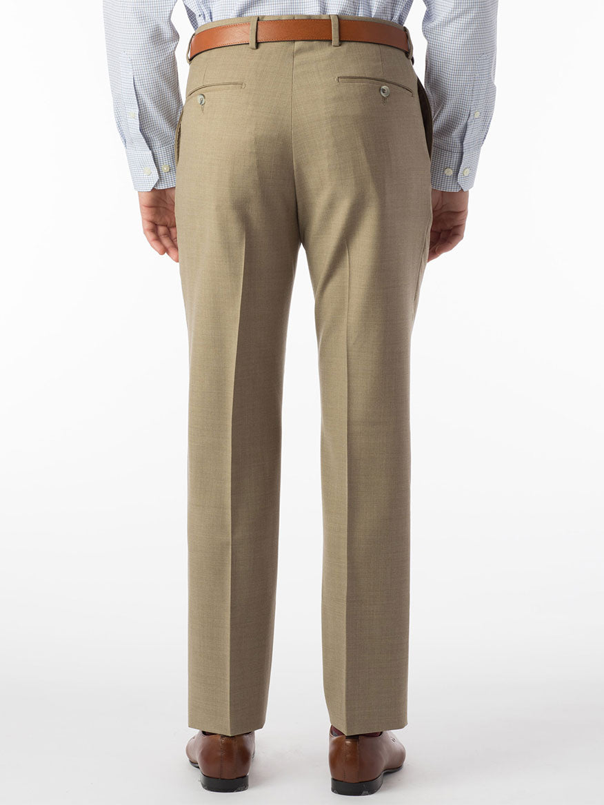 The back view of a man wearing Ballin Soho Comfort 'EZE' Super 120s Modern Flat Front Pant in Tan during a performance.