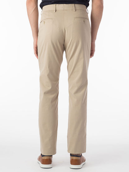 The back view of a man wearing Ballin Atwater True Khaki Modern Flat Front Pant in Khaki pants.