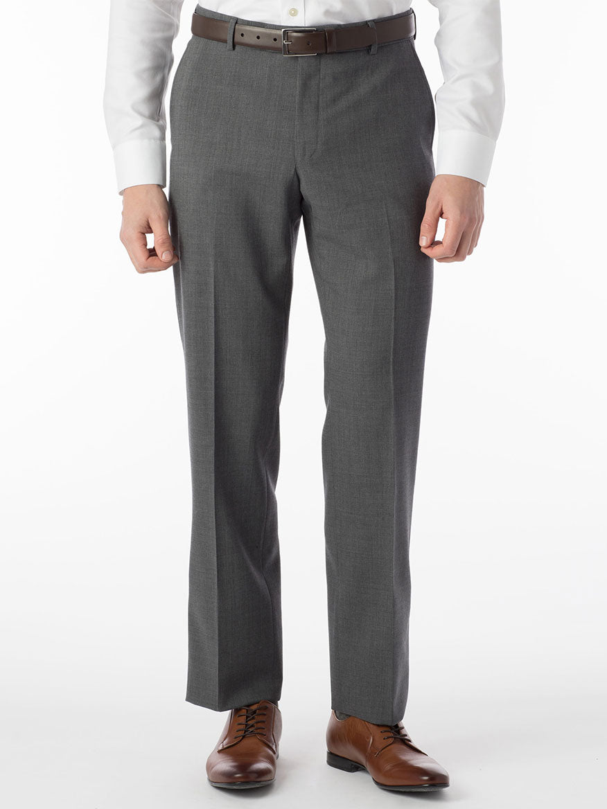 A man is dressed in a stylish Ballin Soho Comfort 'EZE' Super 120s Modern Flat Front Twill Pant in Mid Grey, paired with a crisp white shirt for added comfort.