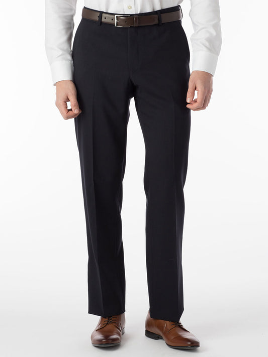 A man wearing the Ballin Soho Comfort 'EZE' Super 120s Modern Flat Front Twill Pant in Navy and a white shirt made with Nanotex fabric for added comfort.