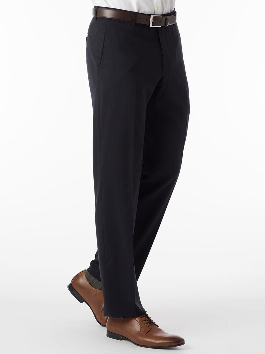 A man in a Ballin Soho Comfort 'EZE' Super 120s Modern Flat Front Twill Pant in Navy suit and tie is standing on a white background.