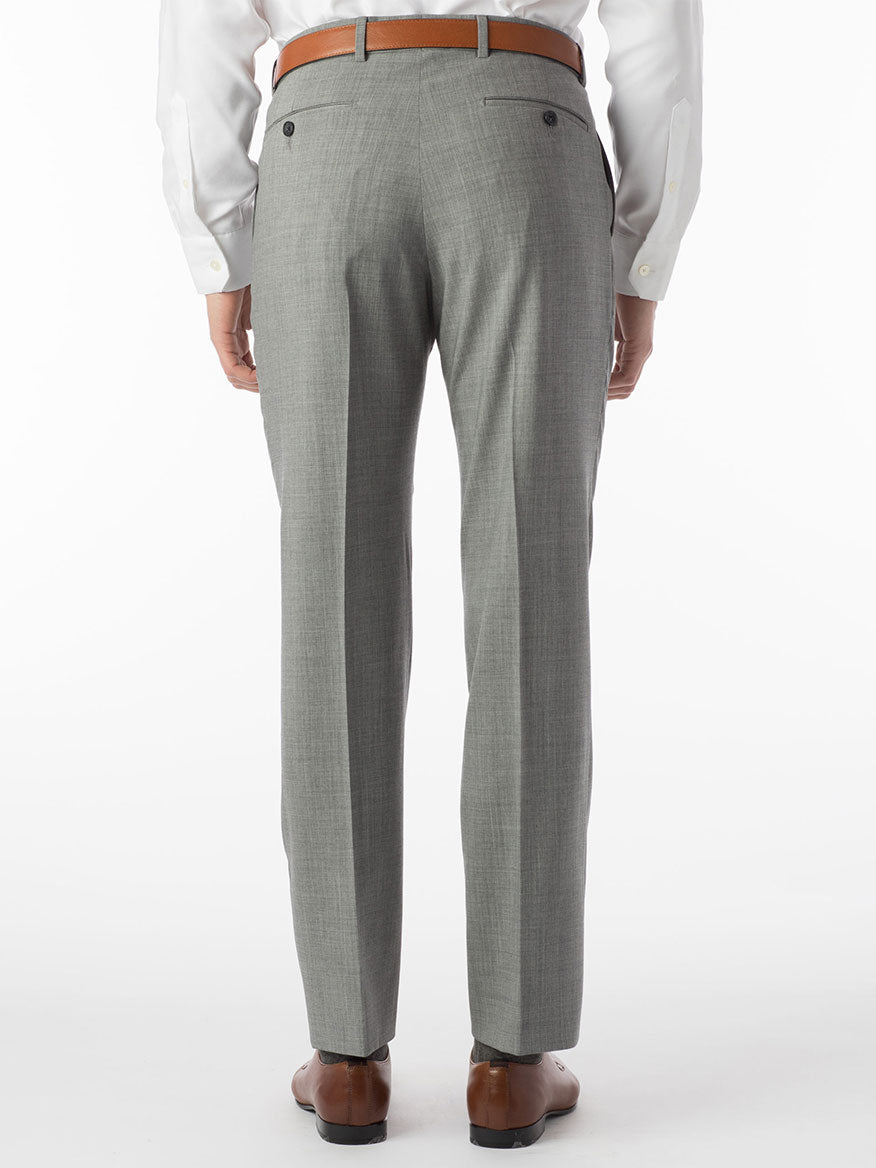 A person shown from the back against a white background wears Ballin Soho Comfort 'EZE' Super 120s Modern Flat Front Twill Pant in Pearl Grey, a brown belt, white shirt, and brown dress shoes.