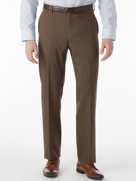 A man wearing brown dress pants with a comfortable "Ballin Soho Comfort 'EZE' Super 120s Modern Flat Front Twill Pant in Saddle" waistband and a white shirt.
