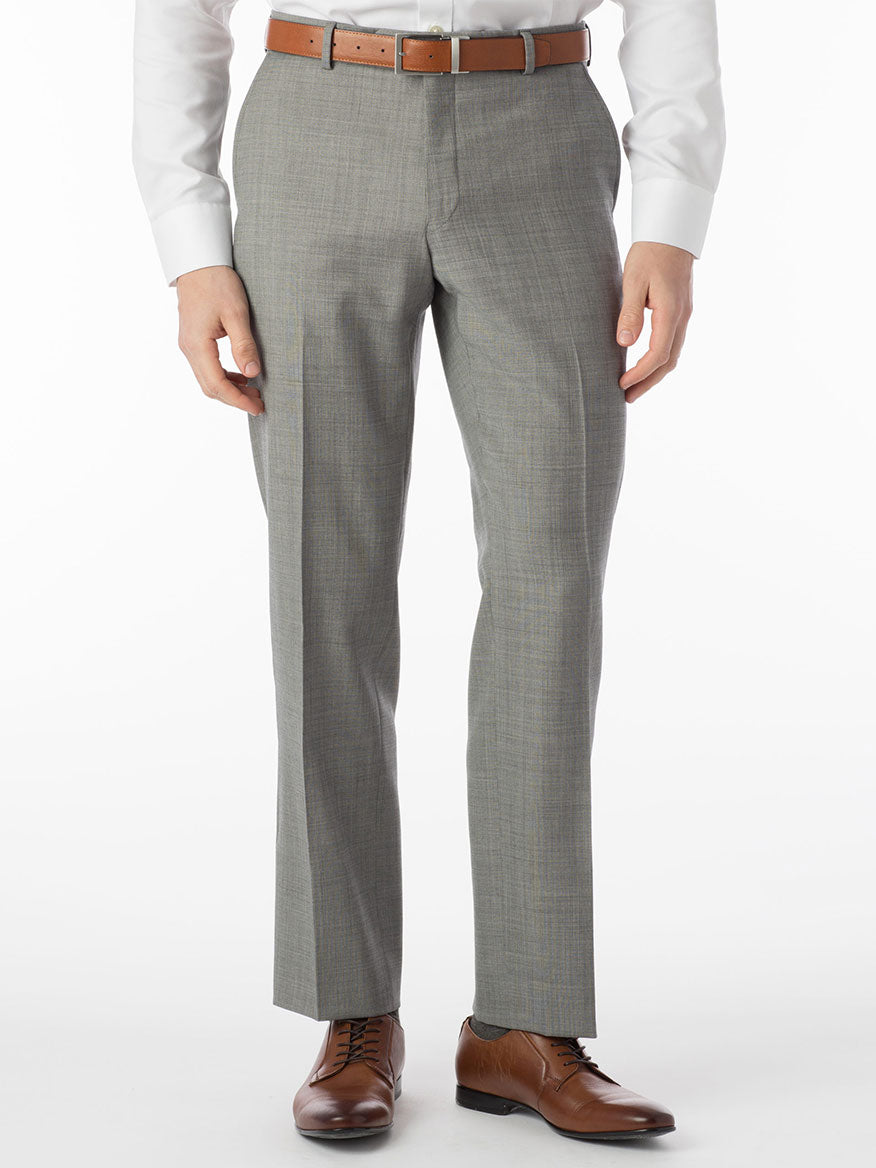 A person in a white shirt and gray Ballin Soho Comfort 'EZE' Sharkskin Modern Flat Front Pant in Houndstooth stands against a plain background, complemented by a brown belt and brown leather shoes.
