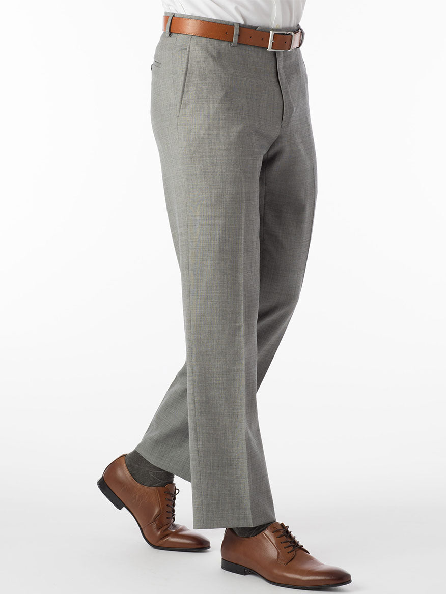 A person wearing Ballin Soho Comfort 'EZE' Sharkskin Modern Flat Front Pants in houndstooth, paired with a brown belt and brown shoes against a white background.