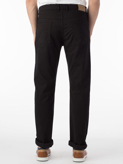 The back view of a man wearing Ballin Crescent Modern 5 Pocket Twill Pants in Black made with premium stretch twill.