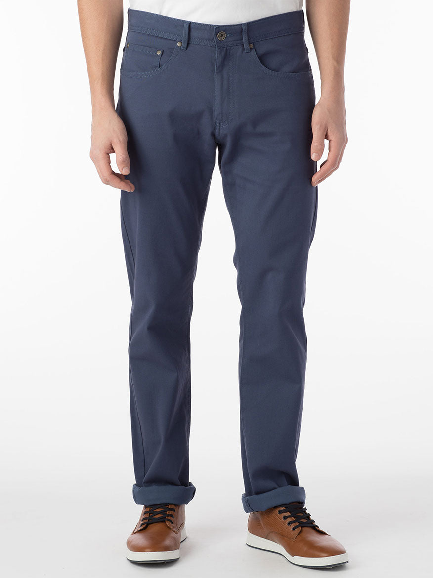A man wearing Ballin Crescent Modern 5 Pocket Twill Pants in Cadet and a white t-shirt.