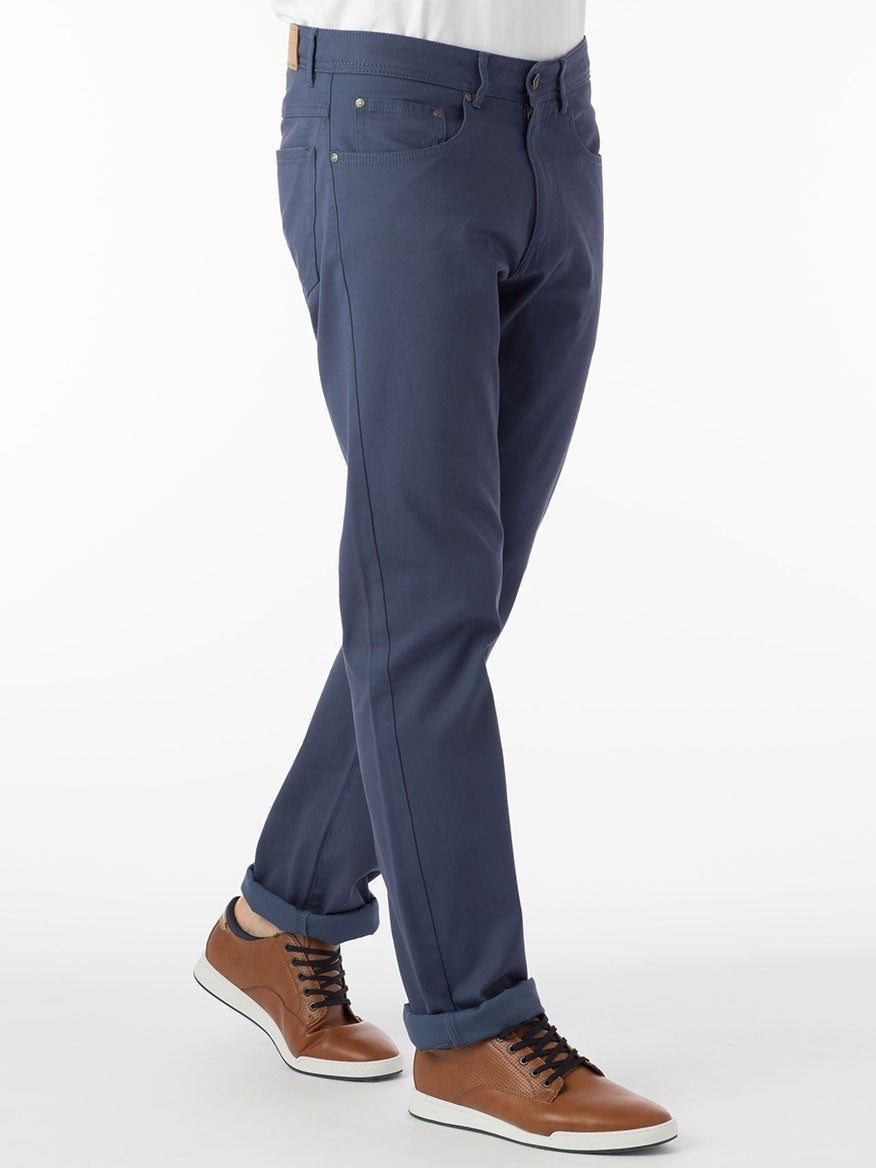 A man wearing Ballin Crescent Modern 5 Pocket Twill Pants in Cadet made of premium stretch twill fabric and a white t-shirt.