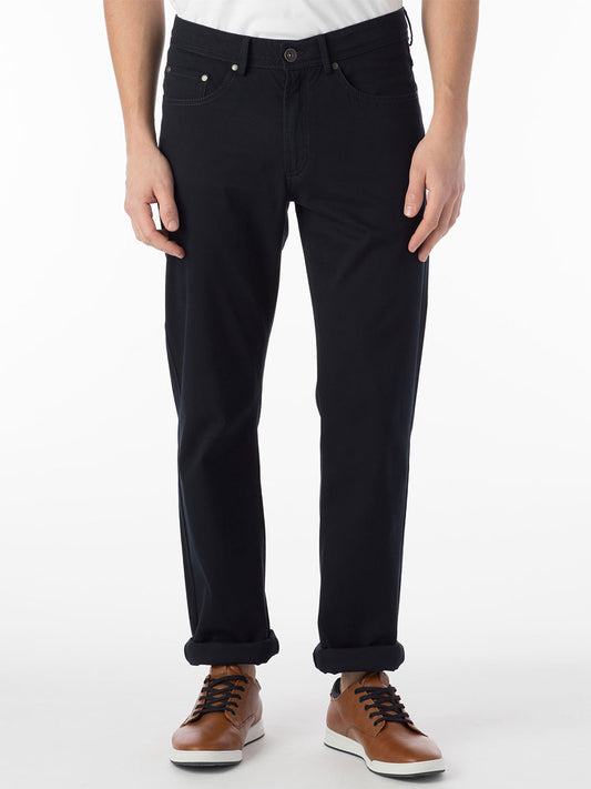 A man wearing Ballin Crescent Modern 5 Pocket Twill Pants in Navy and a white t-shirt.