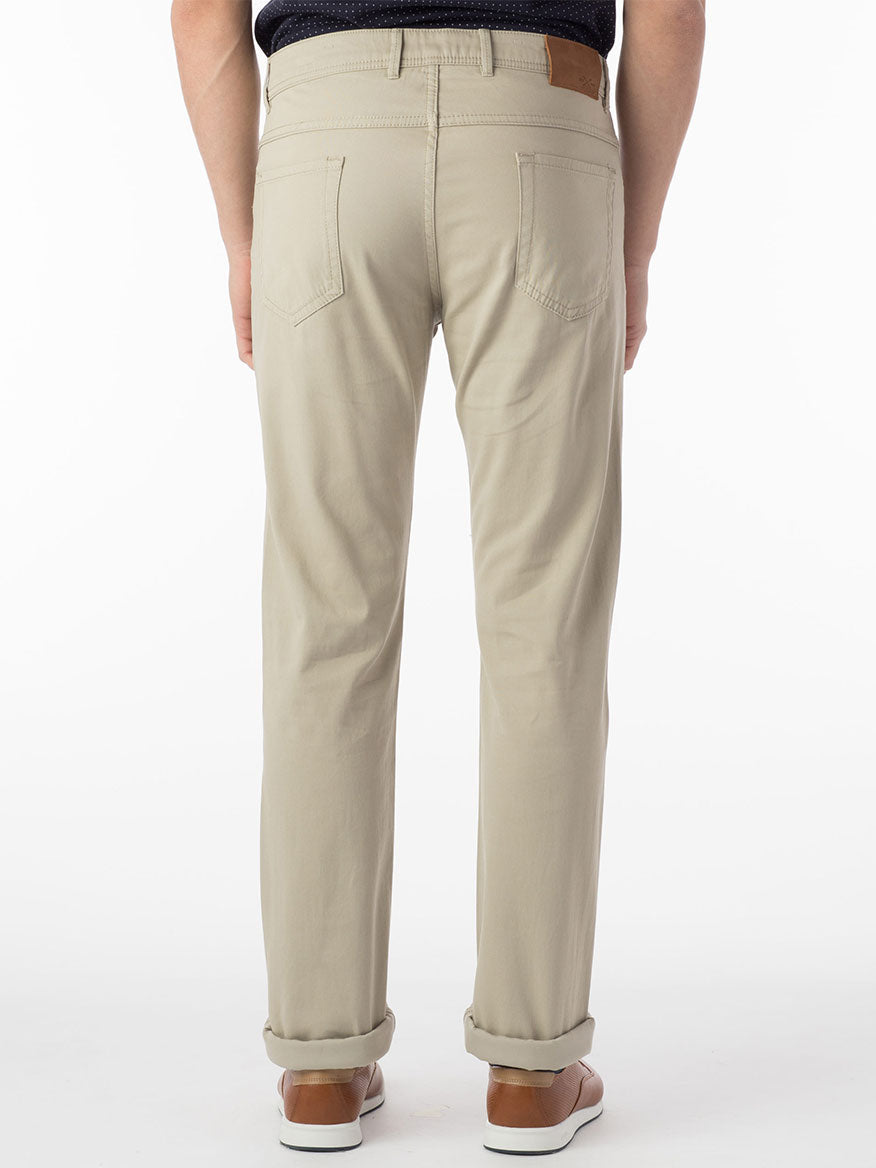 The back view of a man wearing Ballin Crescent Modern 5 Pocket Twill Pants in Stone.
