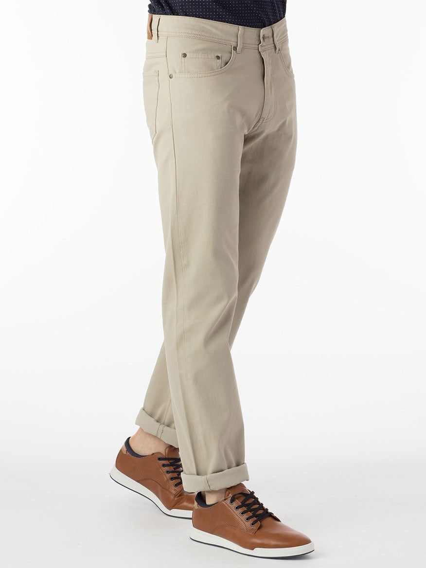 A man wearing Ballin Crescent Modern 5 Pocket Twill Pants in Stone and a black t-shirt.