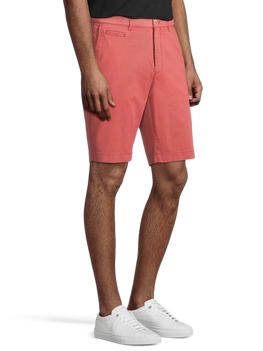 A man wearing Brax Bari Triplestone Printed Modern Fit Short in Melon Bermuda shorts and white sneakers standing against a white background.