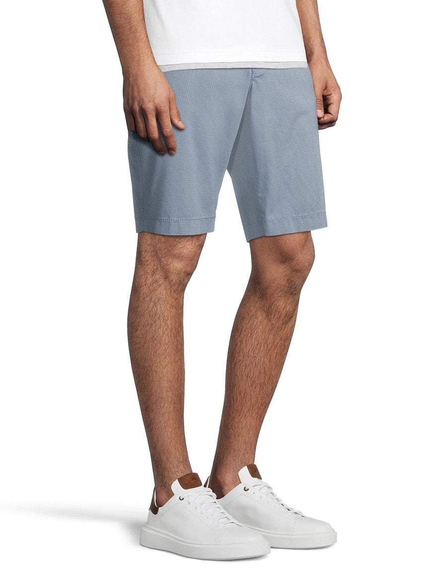 Man wearing Brax Bari Triplestone Printed Modern Fit Short in Smoke Blue and white sneakers standing against a white background.