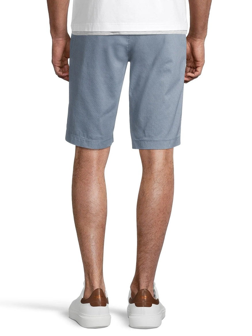Man standing in Brax Bari Triplestone Printed Modern Fit Short in Smoke Blue and white sneakers with brown accents from a rear view.