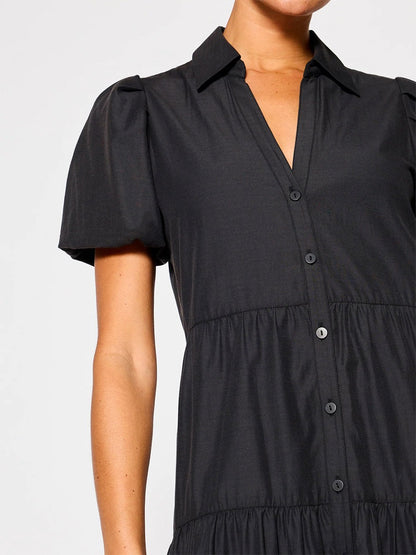 Woman wearing a versatile black button-up Brochu Walker Havana Dress in Washed Black with short sleeves and a collar.