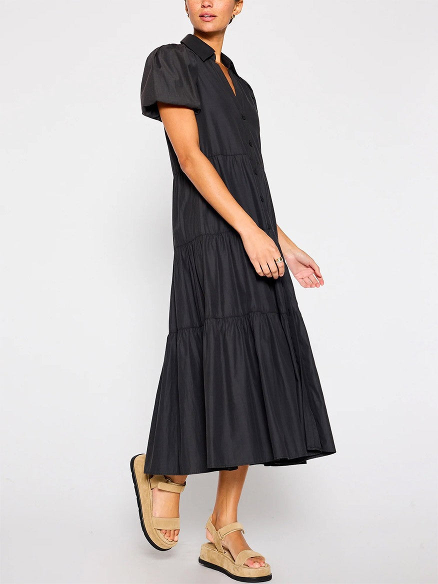 A woman in a versatile, flowy Brochu Walker Havana Dress in Washed Black with short sleeves and espadrille sandals.
