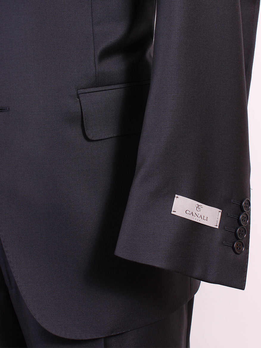 Close-up of a person's arm in a dark suit, showing a label on the sleeve reading "Canali." The Canali Contemporary Fit Suit in Navy, Made in Italy, features buttons on the cuff and a pocket.