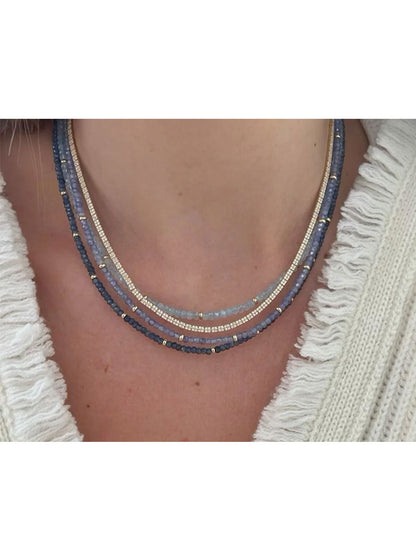 A woman is wearing a EF Collection Birthstone Necklace with Gold Rondelles - Tanzanite.